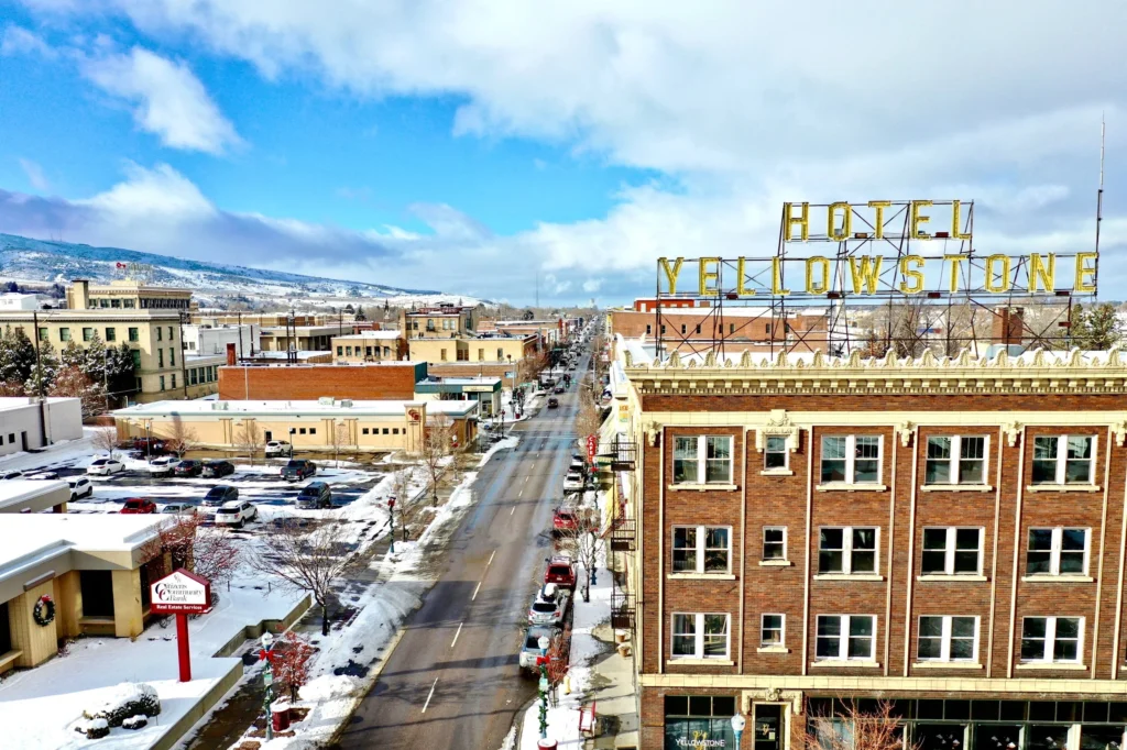 A view of a city street with a hotel sign on top of a building.